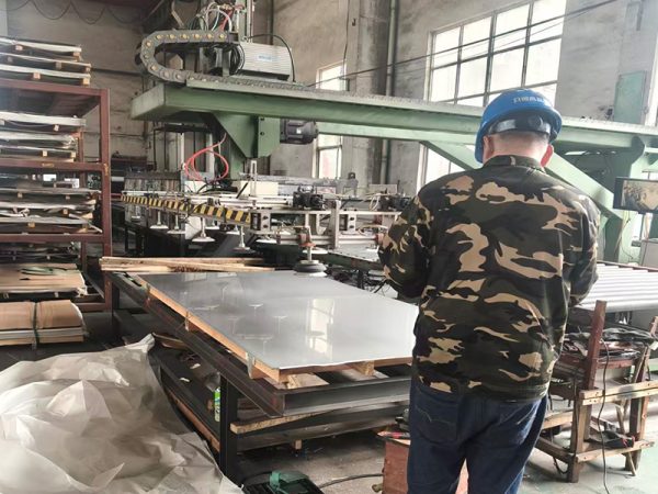 Worker at manufacture workshop operating cidan folding machine; Shutterstock ID 232675477; purchase_order: -; job: -; client: -; other: -