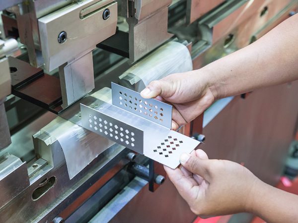 Worker at manufacture workshop operating cidan folding machine; Shutterstock ID 232675477; purchase_order: -; job: -; client: -; other: -